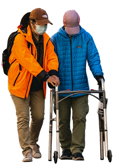 Caregiver helping a person use a walker