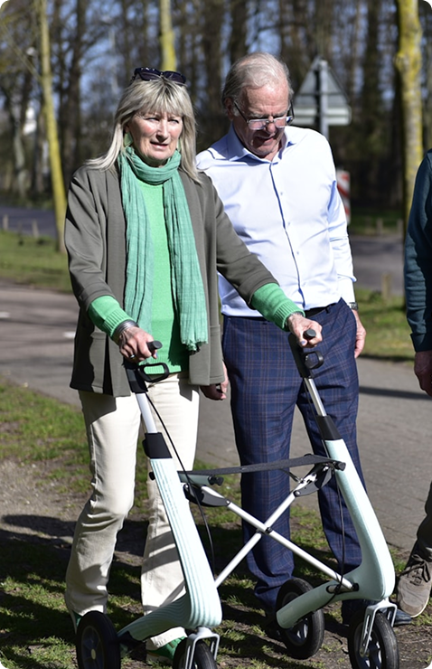 Senior woman walking outdoors with a rollator walker