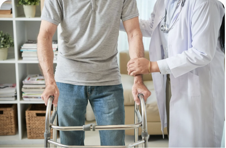 Doctor assisting a senior man using a walker indoors