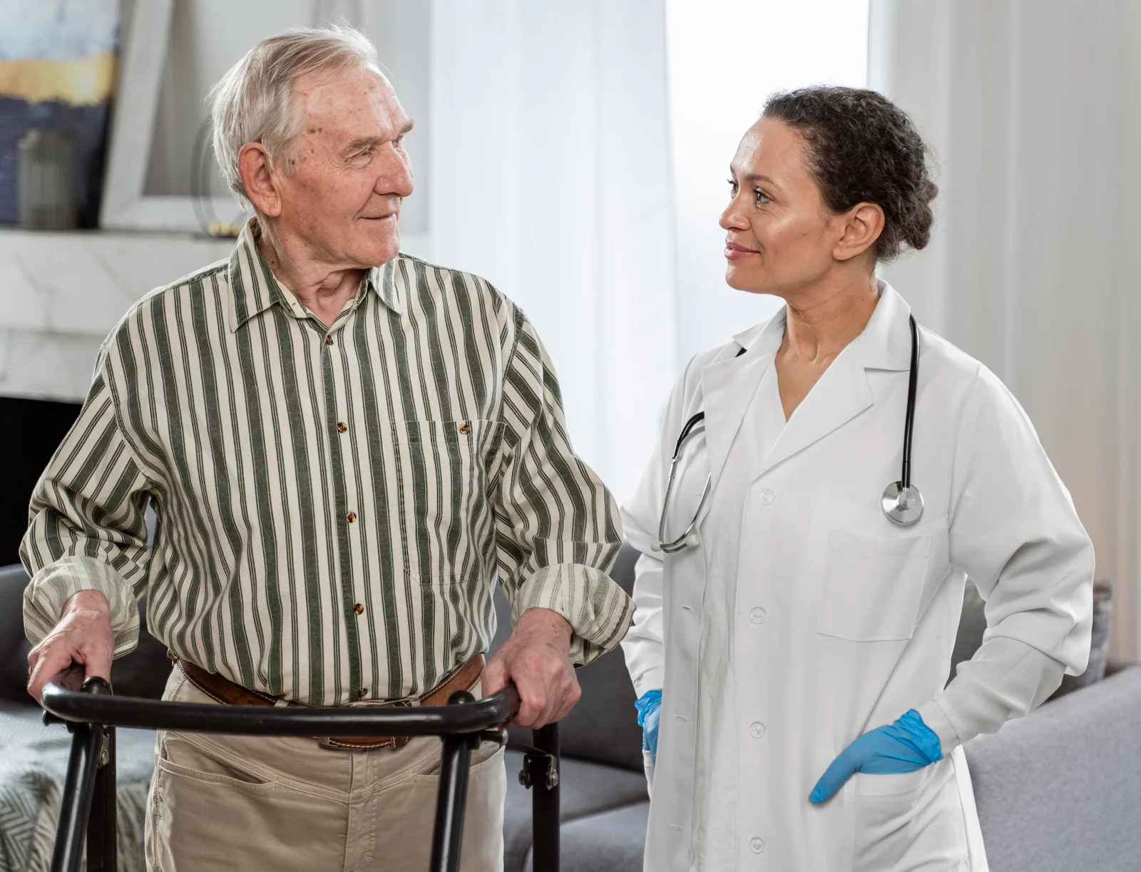 Doctor speaking with a senior man using a walker