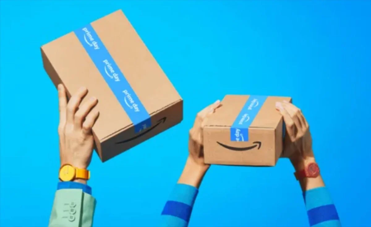 Hands holding Amazon delivery boxes